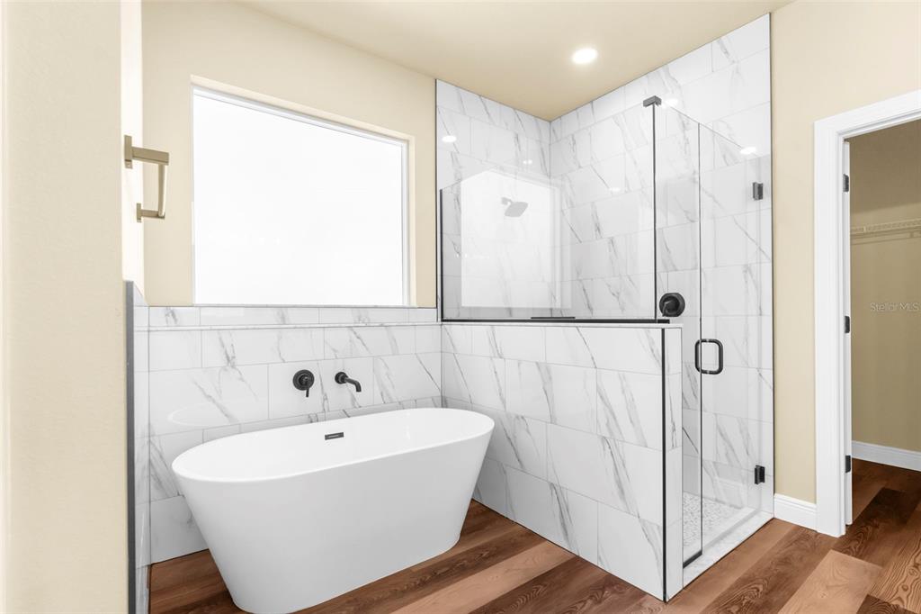 16143 Penn State Road Weeki Wachee, FL 34614 - Photo 26 of 45 a white bath tub sitting next to a shower