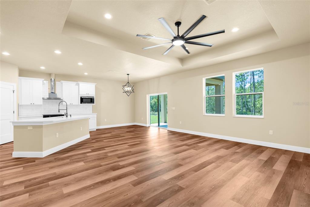 16143 Penn State Road Weeki Wachee, FL 34614 - Photo 32 of 45 a view of an empty room with window and wooden floor
