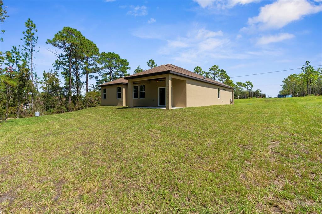 16143 Penn State Road Weeki Wachee, FL 34614 - Photo 43 of 45 a view of a house with a yard