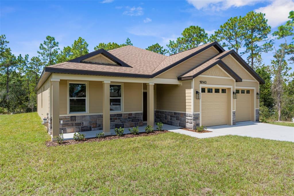 16143 Penn State Road Weeki Wachee, FL 34614 - Photo 6 of 45 a front view of a house with a yard