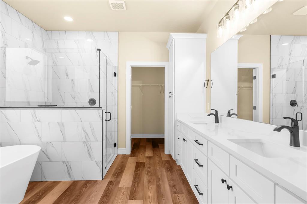 16143 Penn State Road Weeki Wachee, FL 34614 - Photo 7 of 45 a spacious bathroom with a double vanity sink a mirror and a shower