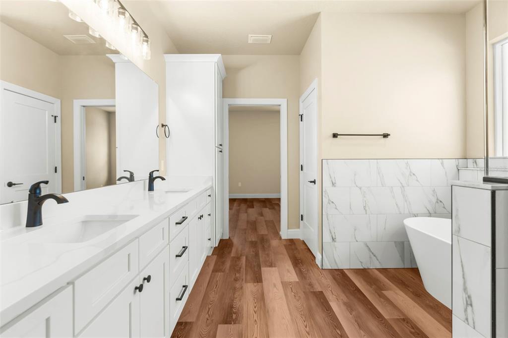 16143 Penn State Road Weeki Wachee, FL 34614 - Photo 8 of 45 a spacious bathroom with a double vanity sink and a mirror