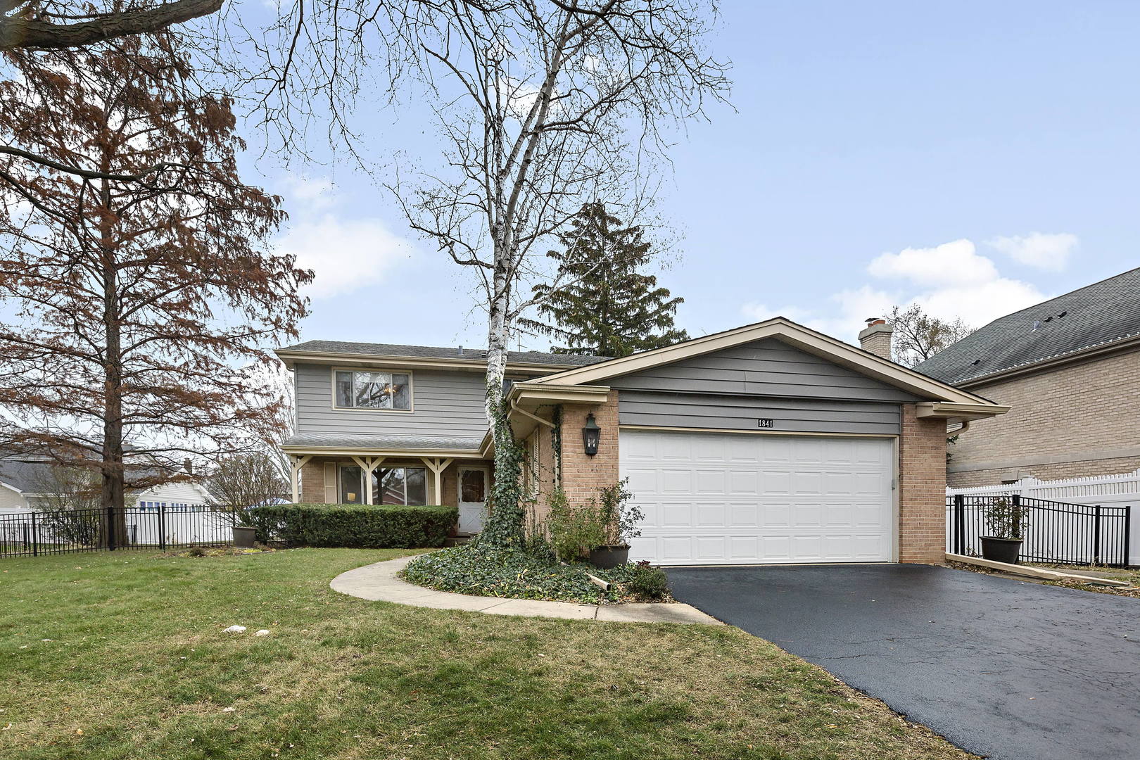 1841 Birch Road Northbrook, IL 60062 - Photo 1 of 18 a front view of a house with a yard and garage