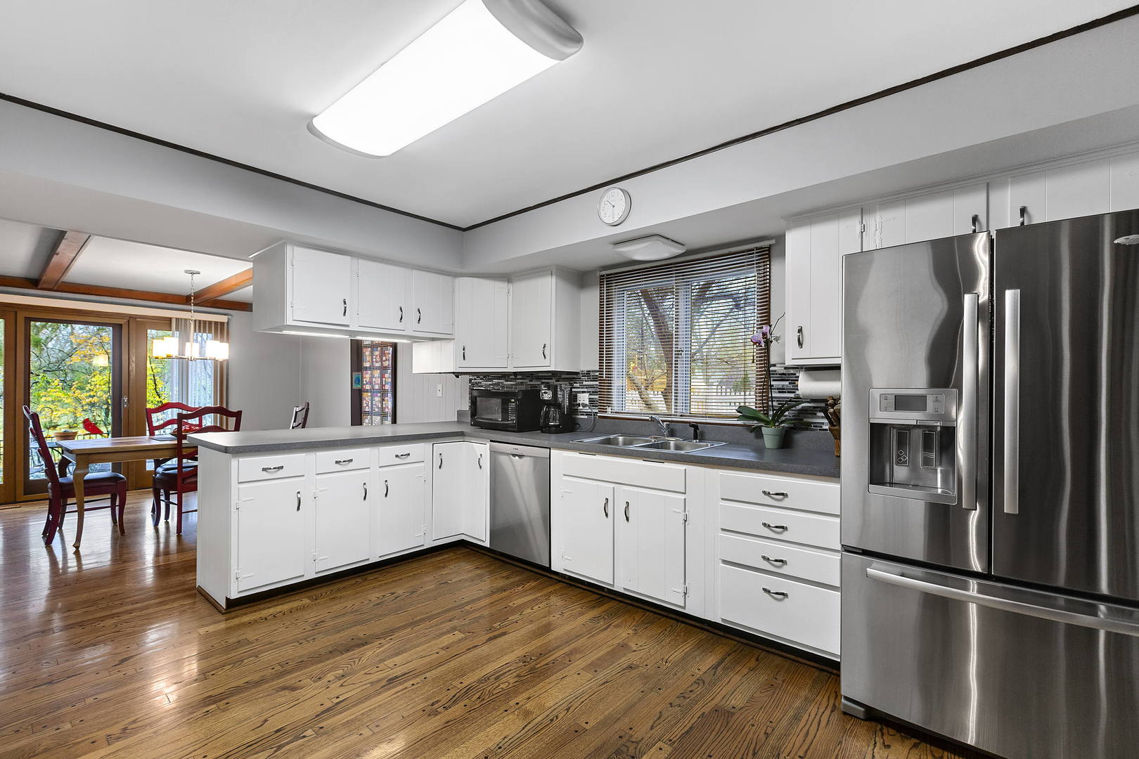 1841 Birch Road Northbrook, IL 60062 - Photo 4 of 18 a kitchen with white cabinets and stainless steel appliances
