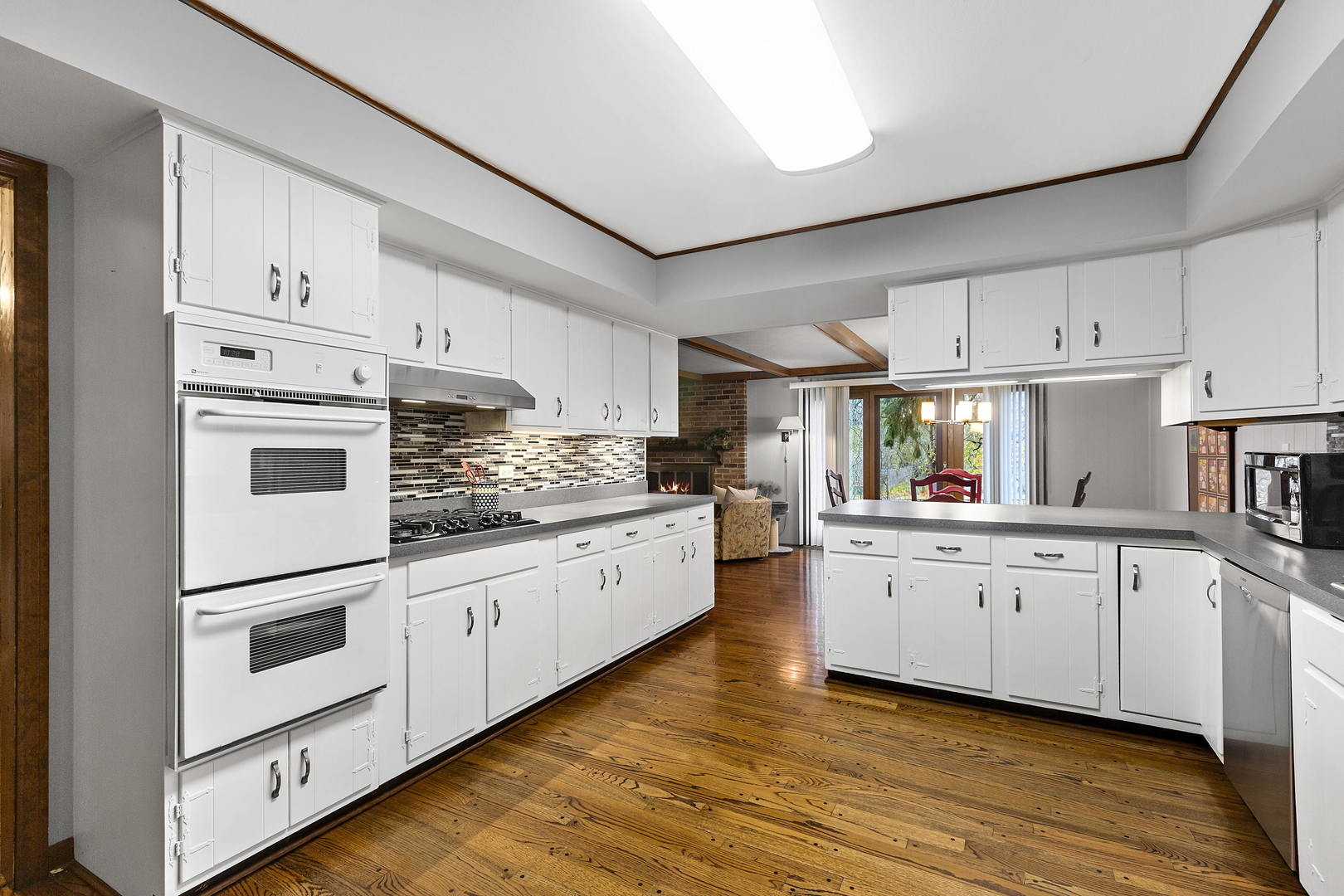 1841 Birch Road Northbrook, IL 60062 - Photo 5 of 18 a kitchen with granite countertop white cabinets and white appliances
