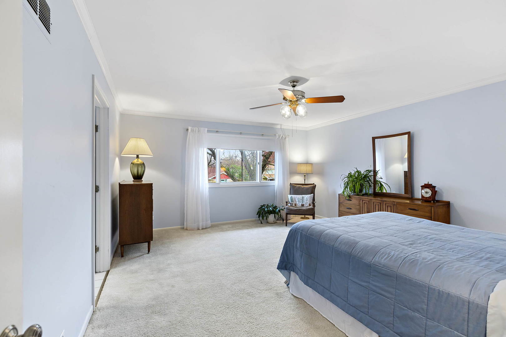 1841 Birch Road Northbrook, IL 60062 - Photo 10 of 18 a bedroom with a bed and a chandelier
