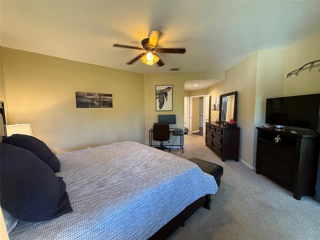 9237 Northwest 9th Place, Unit 9237 Plantation, FL 33324 - Photo 19 of 44 a bedroom with a bed and a chandelier