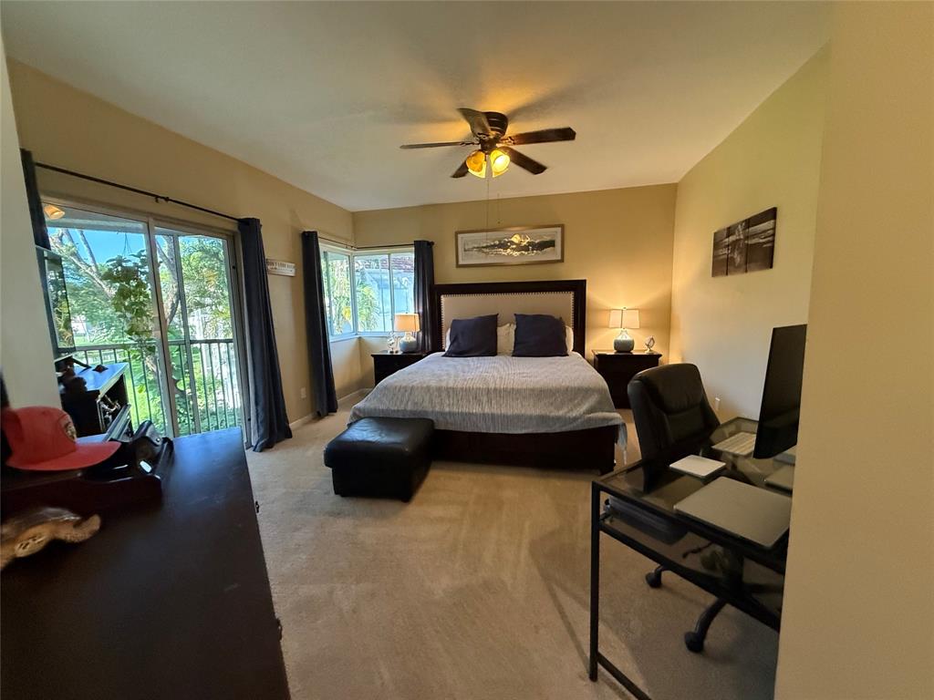 9237 Northwest 9th Place, Unit 9237 Plantation, FL 33324 - Photo 21 of 44 a bedroom with a bed and a chandelier
