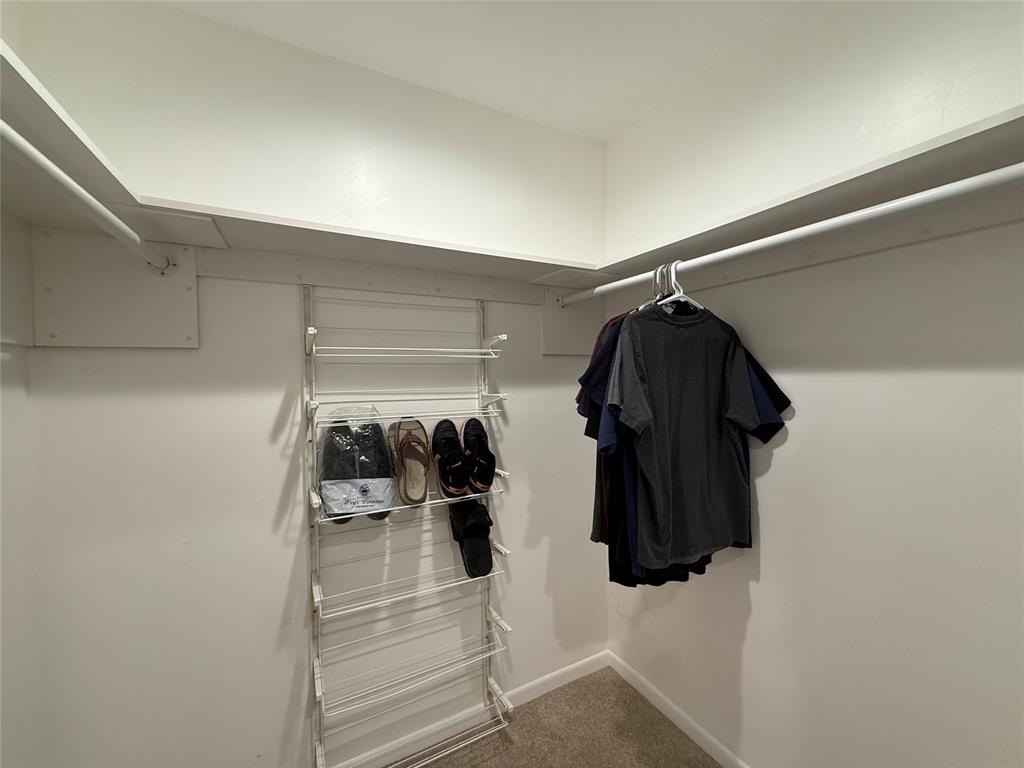 9237 Northwest 9th Place, Unit 9237 Plantation, FL 33324 - Photo 23 of 44 a view of walk in closet with clothes and shoes