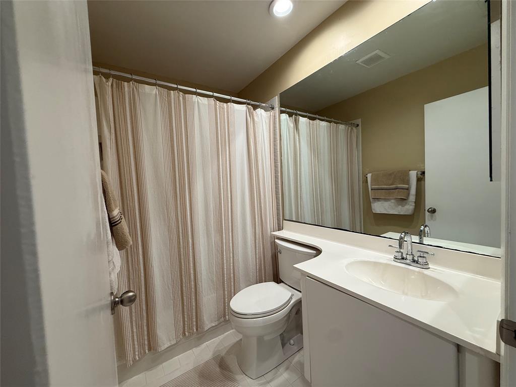 9237 Northwest 9th Place, Unit 9237 Plantation, FL 33324 - Photo 26 of 44 a bathroom with a toilet a sink and a mirror