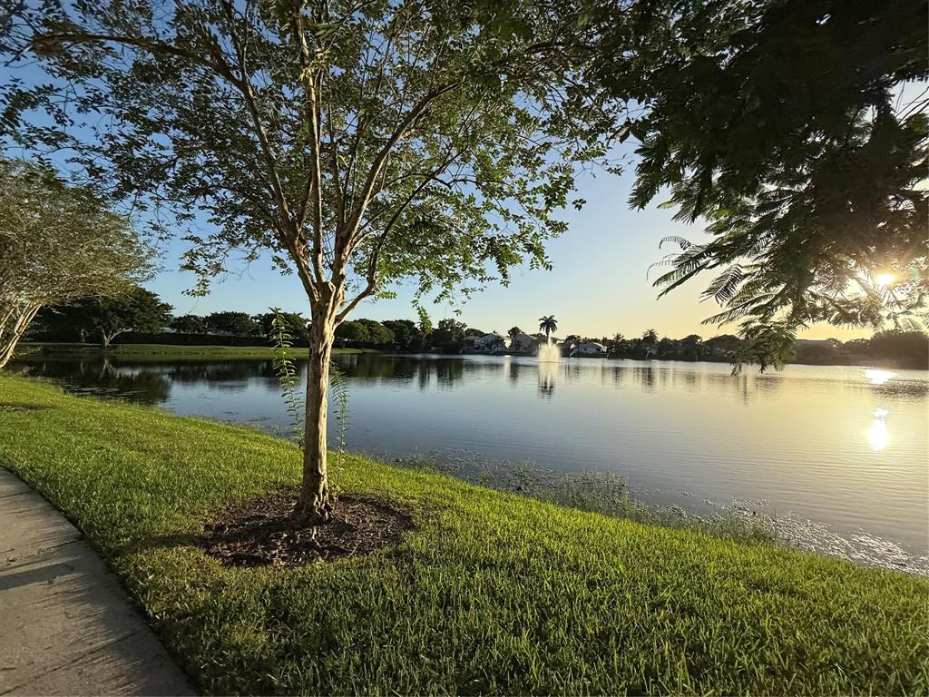 9237 Northwest 9th Place, Unit 9237 Plantation, FL 33324 - Photo 36 of 44 a view of a lake with a house in the background