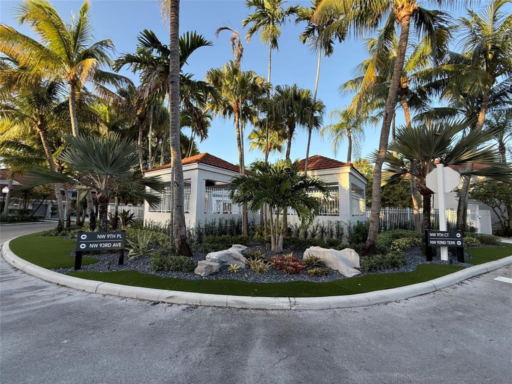 9237 Northwest 9th Place, Unit 9237 Plantation, FL 33324 - Photo 38 of 44 a front view of a house with a yard and palm trees