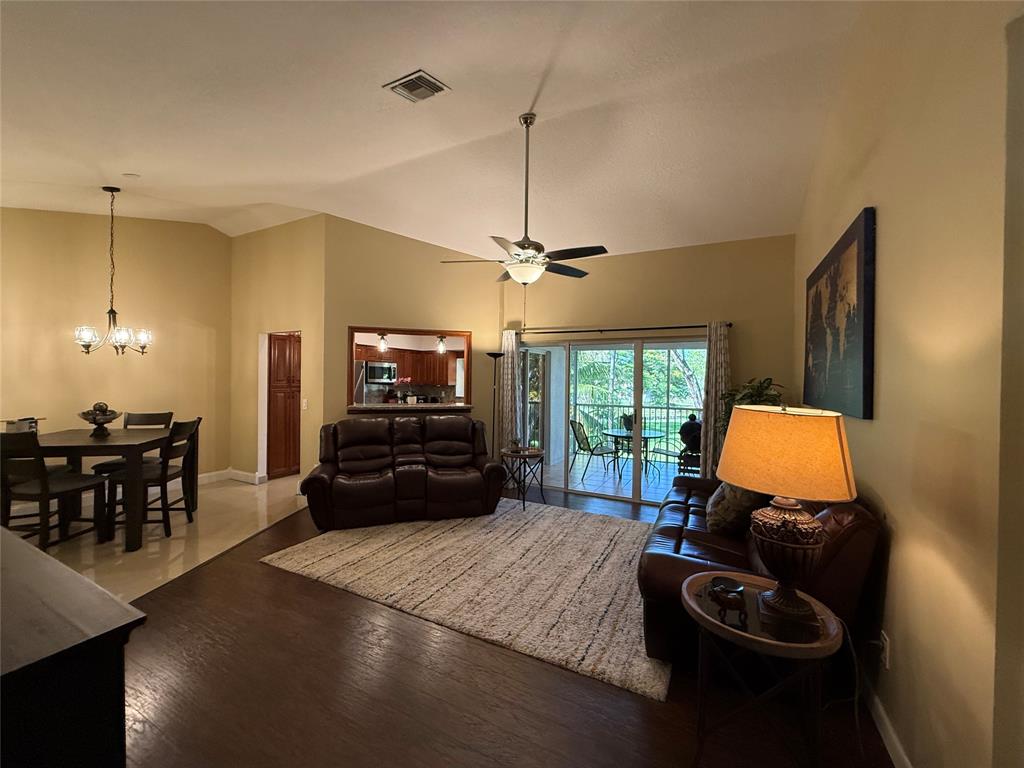 9237 Northwest 9th Place, Unit 9237 Plantation, FL 33324 - Photo 5 of 44 a kitchen with a refrigerator and a table