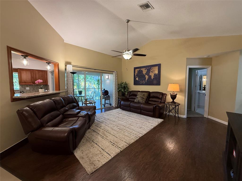 9237 Northwest 9th Place, Unit 9237 Plantation, FL 33324 - Photo 9 of 44 a living room with furniture window and a flat screen tv