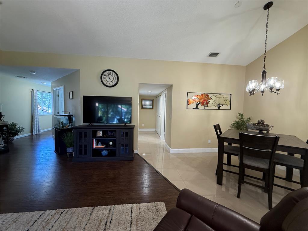 9237 Northwest 9th Place, Unit 9237 Plantation, FL 33324 - Photo 10 of 44 a living room with furniture and a flat screen tv