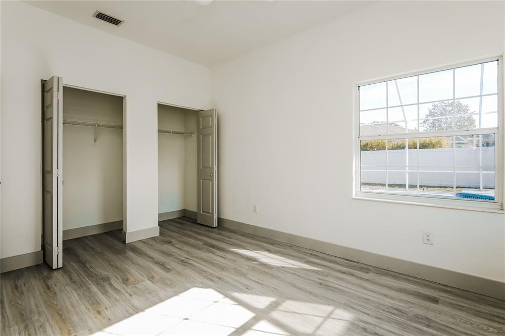 71 Westcedar Lane Palm Coast, FL 32164 - Photo 14 of 20 an empty room with wooden floor and windows