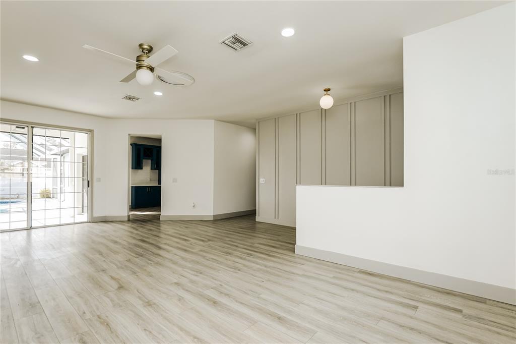 71 Westcedar Lane Palm Coast, FL 32164 - Photo 4 of 20 a view of an empty room with wooden floor and a window