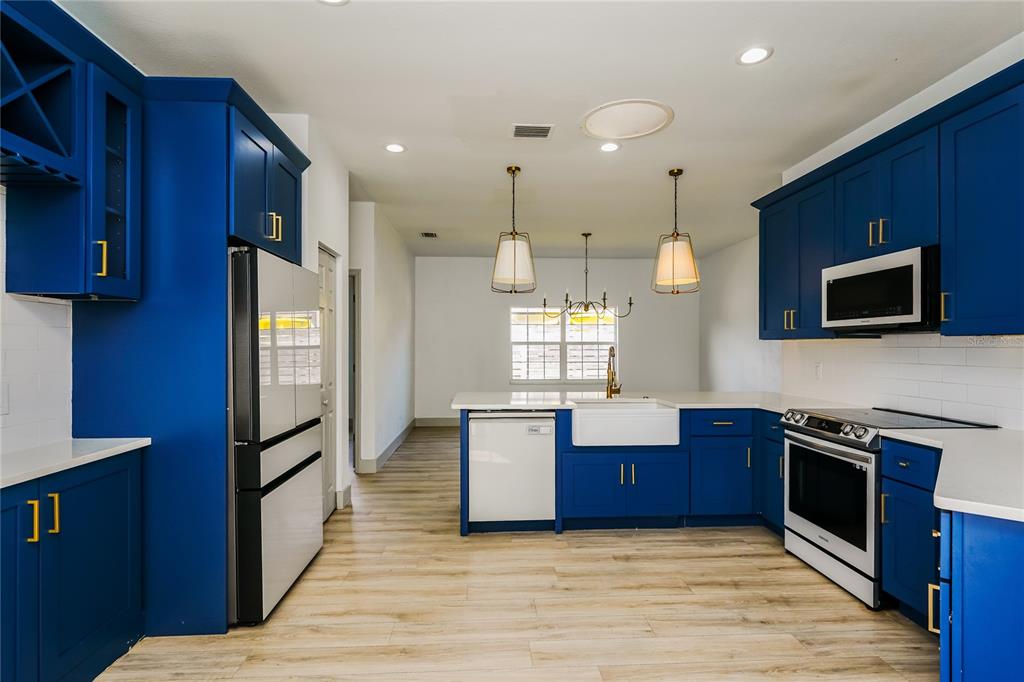 71 Westcedar Lane Palm Coast, FL 32164 - Photo 6 of 20 a kitchen with stainless steel appliances granite countertop wooden cabinets a stove top oven a sink and dishwasher