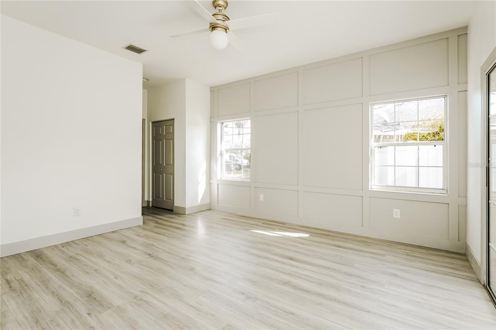 71 Westcedar Lane Palm Coast, FL 32164 - Photo 10 of 20 an empty room with wooden floor and windows