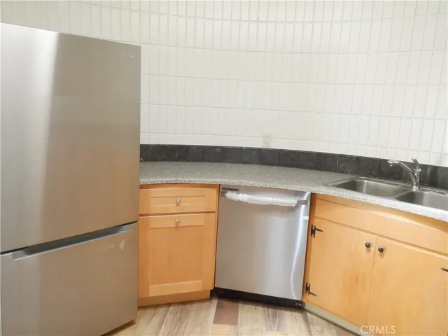 a view of a kitchen sink stove and cabinets