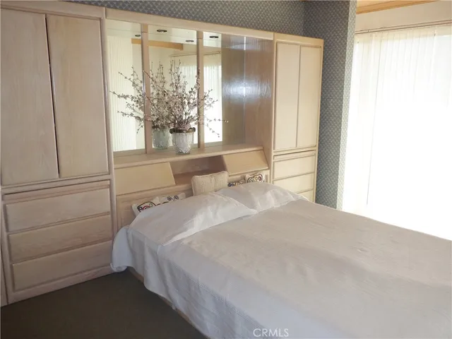 a bathroom with a sink a toilet a mirror and shower