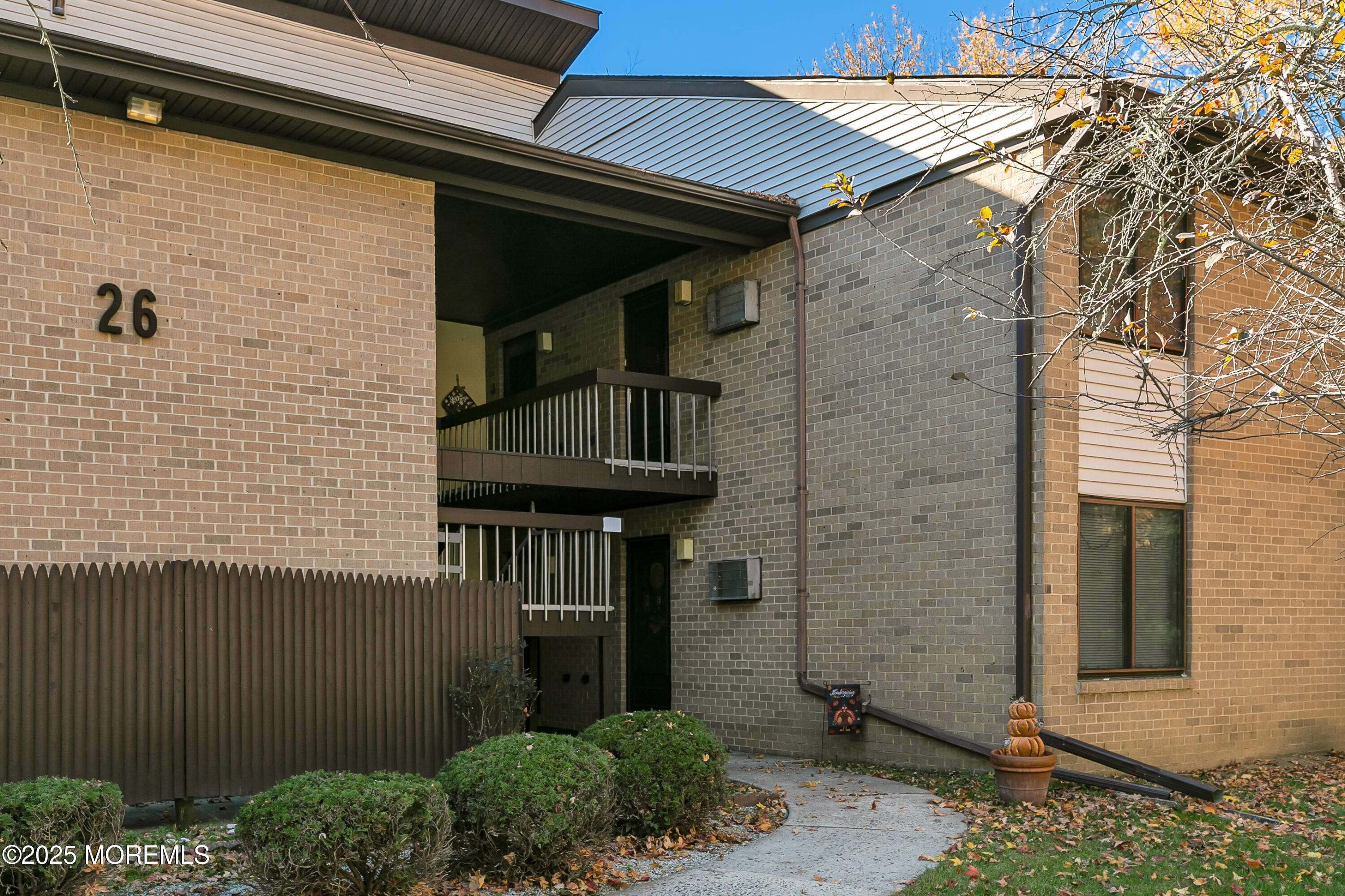 26 Meadow Green Circle, Unit K Manalapan, NJ 07726 - Photo 1 of 27 a front view of a house with a garden
