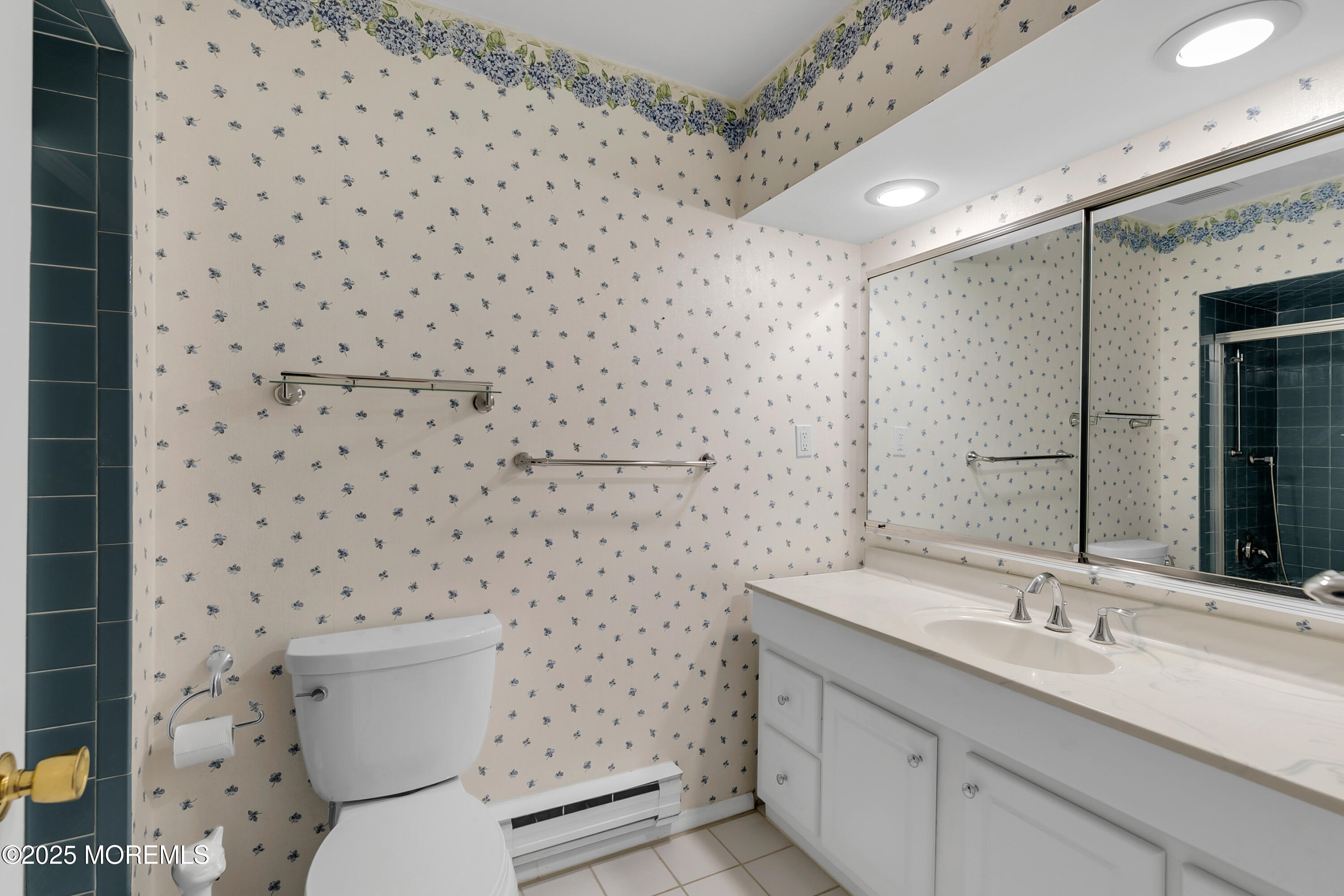 26 Meadow Green Circle, Unit K Manalapan, NJ 07726 - Photo 14 of 27 a bathroom with a granite countertop toilet a sink and a mirror