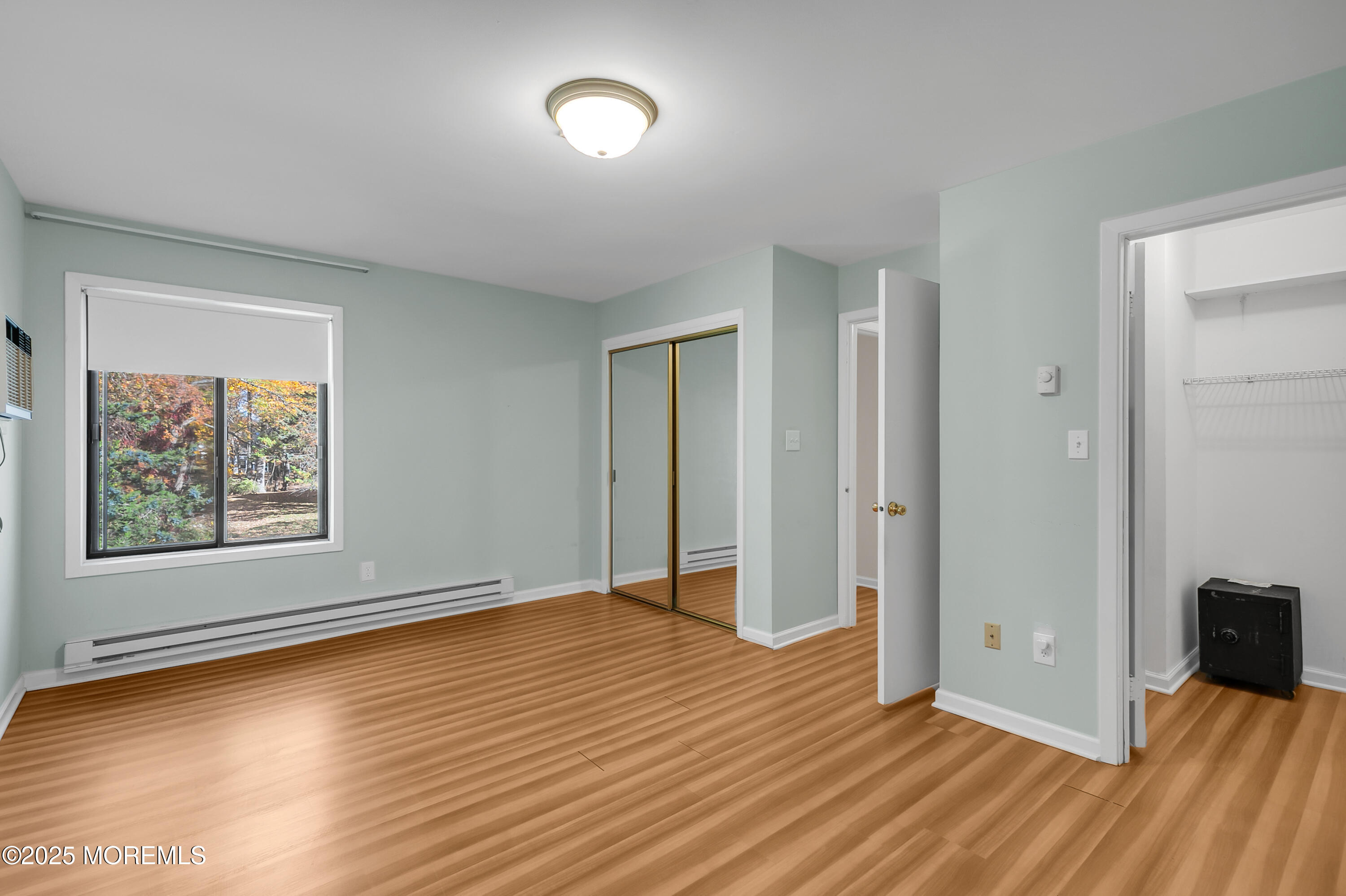 26 Meadow Green Circle, Unit K Manalapan, NJ 07726 - Photo 15 of 27 an empty room with wooden floor and windows