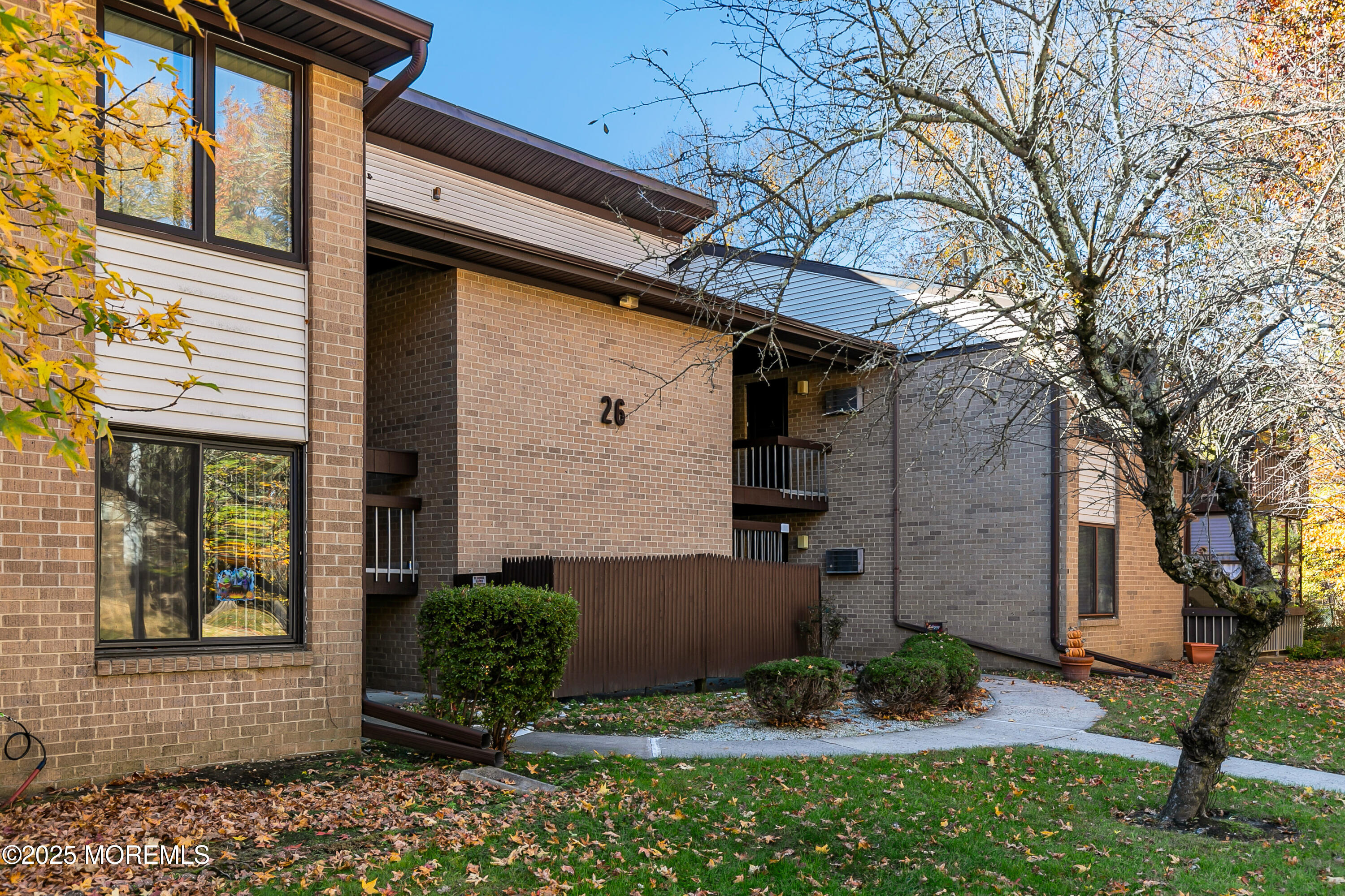26 Meadow Green Circle, Unit K Manalapan, NJ 07726 - Photo 2 of 27 a front view of a house with garden