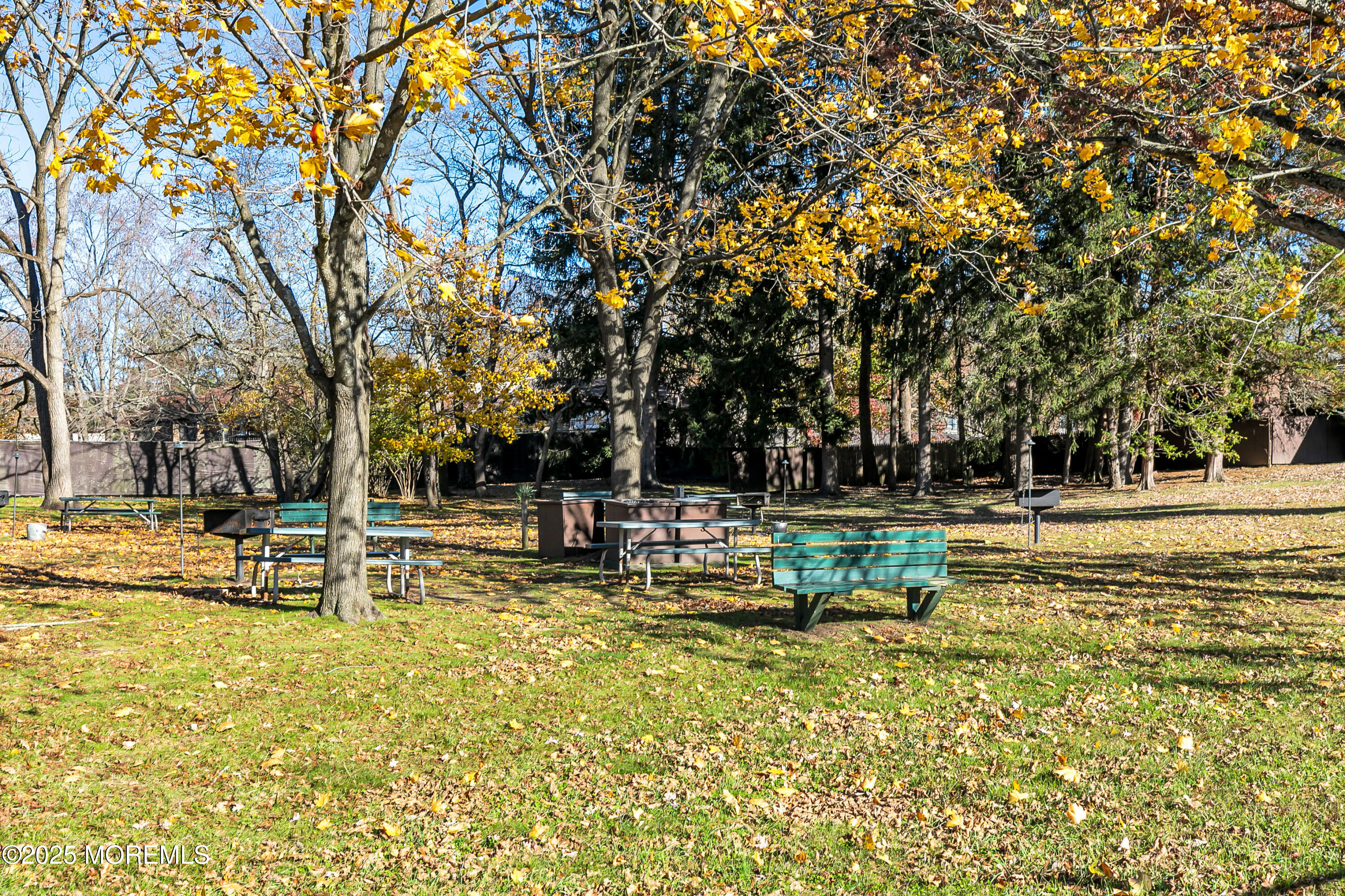 26 Meadow Green Circle, Unit K Manalapan, NJ 07726 - Photo 25 of 27 a view of a swimming pool with a bench