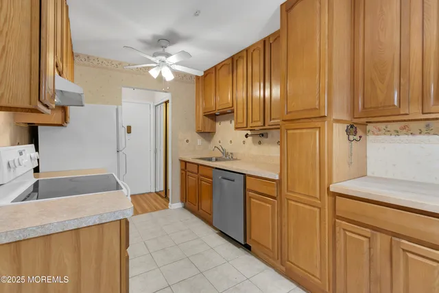 a kitchen with stainless steel appliances granite countertop a sink a stove and a refrigerator