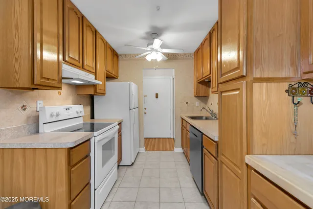 a kitchen with stainless steel appliances a sink and refrigerator