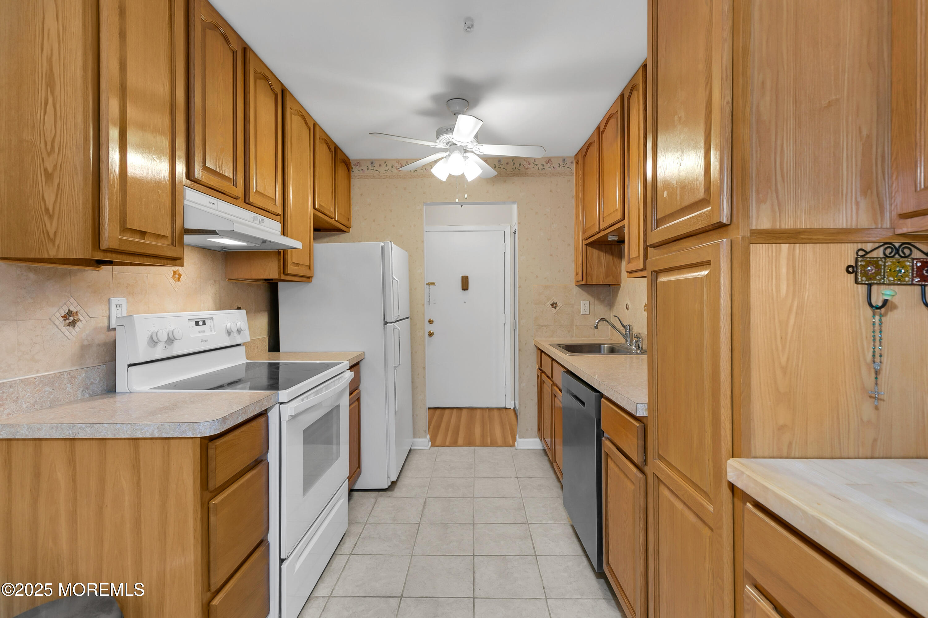 26 Meadow Green Circle, Unit K Manalapan, NJ 07726 - Photo 4 of 27 a kitchen with stainless steel appliances granite countertop a sink a stove and a refrigerator