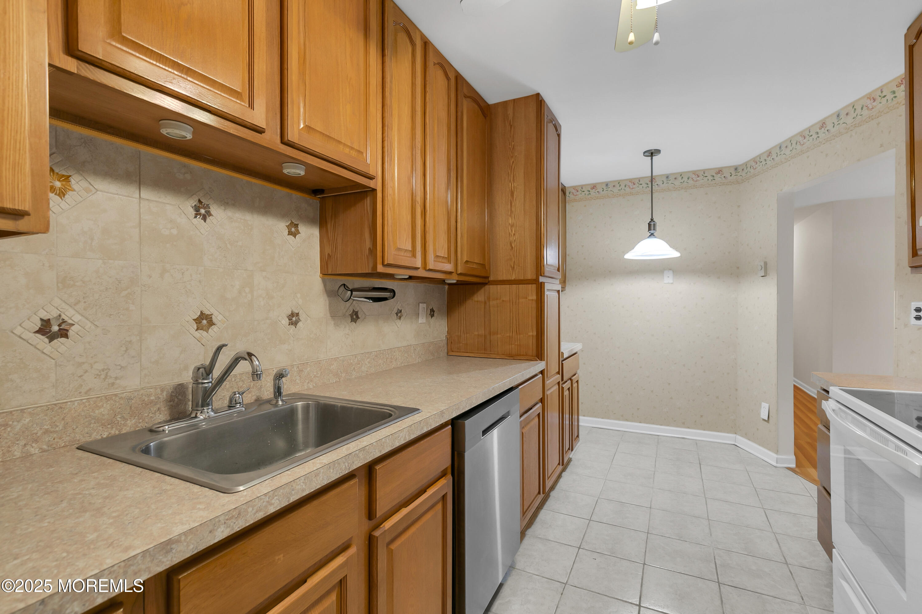 26 Meadow Green Circle, Unit K Manalapan, NJ 07726 - Photo 5 of 27 a kitchen with stainless steel appliances a sink and refrigerator