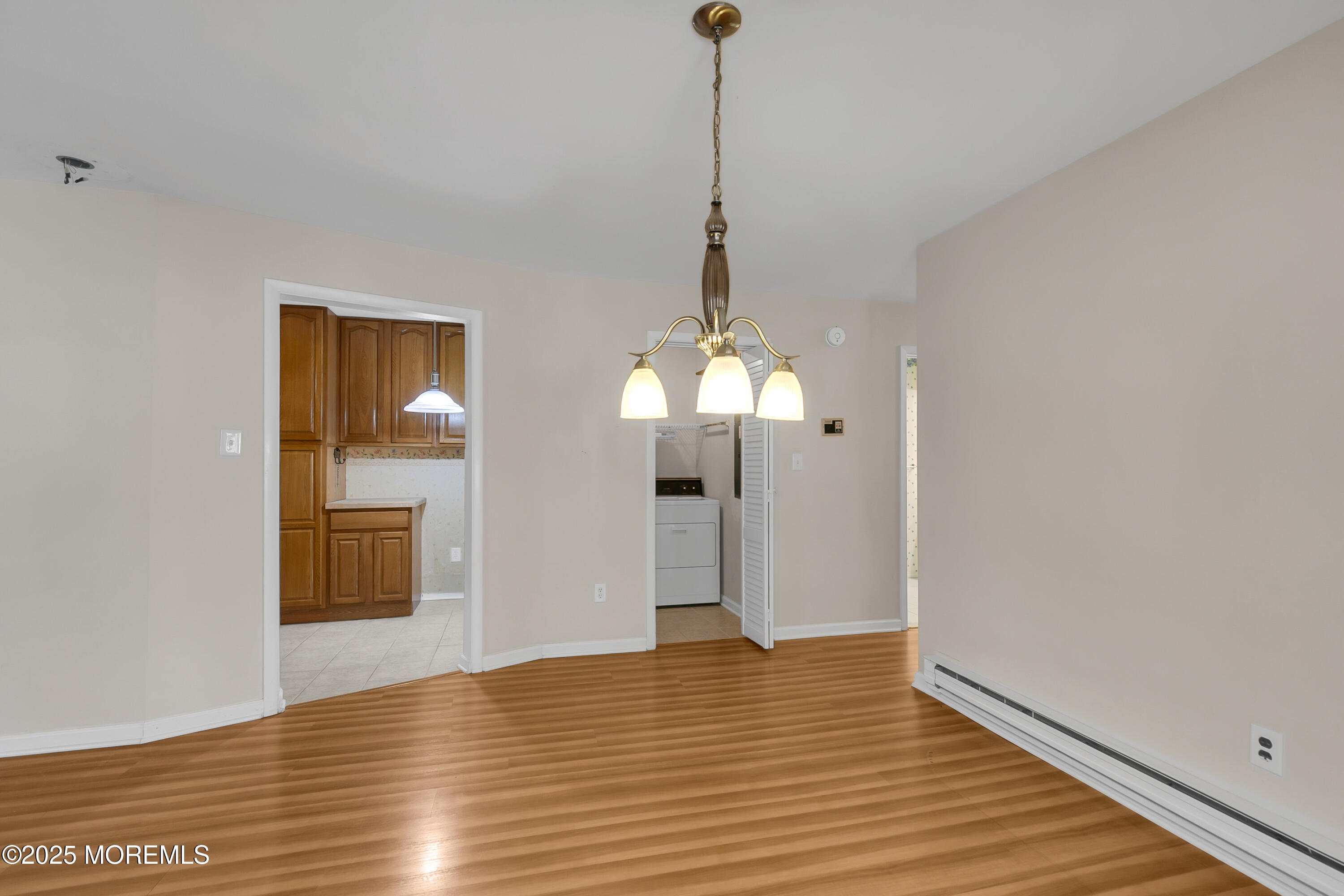 26 Meadow Green Circle, Unit K Manalapan, NJ 07726 - Photo 7 of 27 a view of an empty room with wooden floor and a window