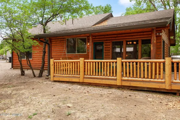 a view of a house with a small yard and wooden fence