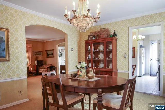 a view of a dining room with furniture and chandelier