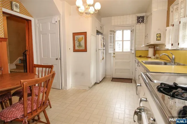 a kitchen that has a sink and a stove in it