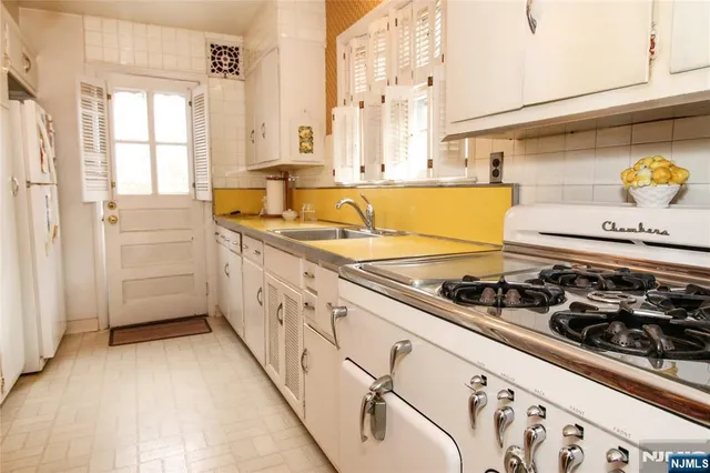a kitchen with a stove a sink and a refrigerator