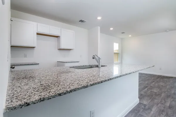 a large kitchen with kitchen island a sink stainless steel appliances and a counter top space
