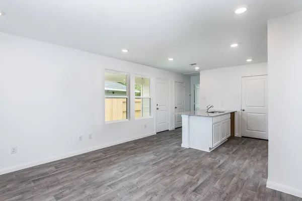 a view of room with window and wooden floor