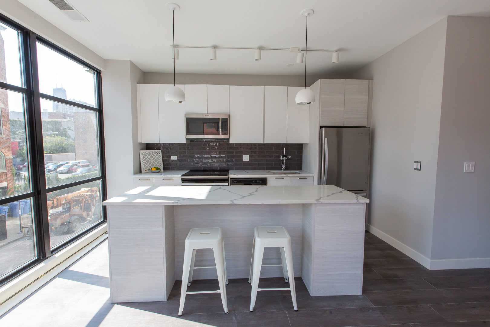 Undisclosed Address Chicago, IL 60610 - Photo 6 of 14 a kitchen with stainless steel appliances a table chairs refrigerator and microwave