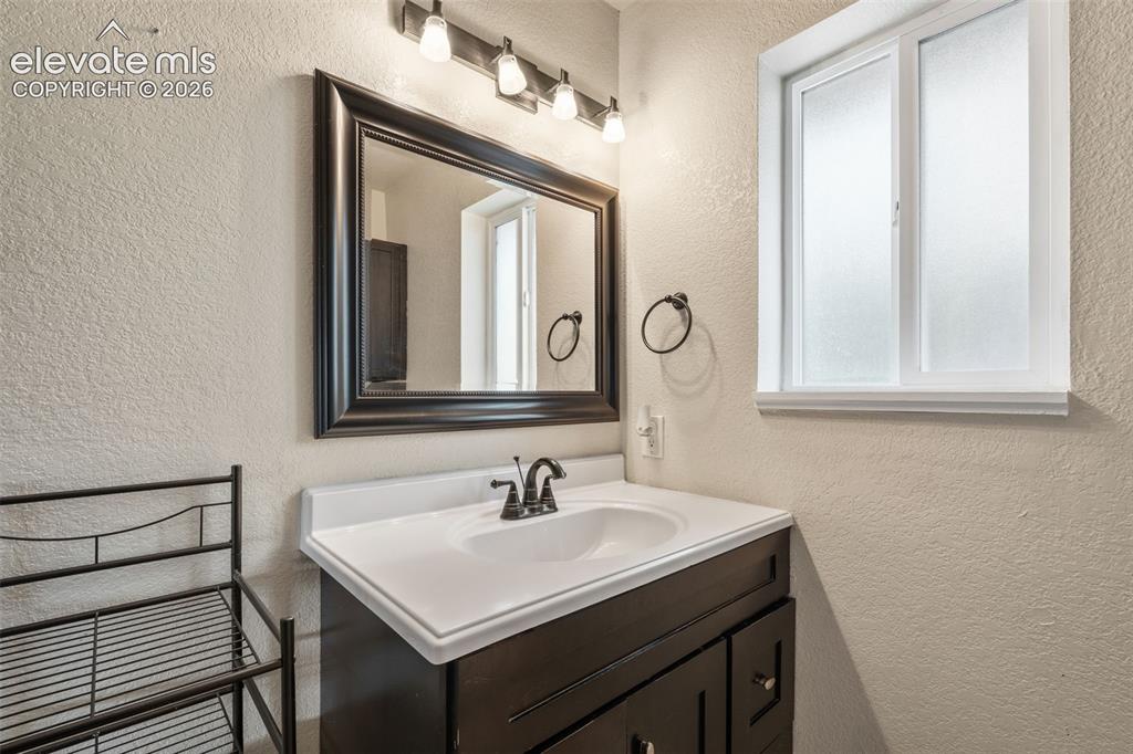 125 Diamond E Road Fountain, CO 80817 - Photo 21 of 43 a bathroom with a sink vanity and a mirror