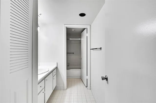a bathroom with a sink vanity tub and shower