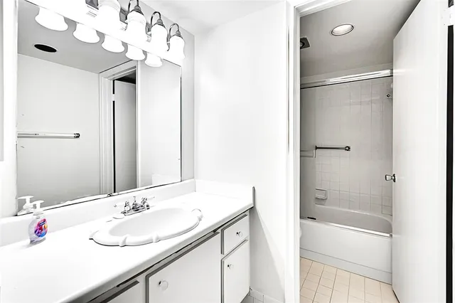 a bathroom with a shower and a bath tub