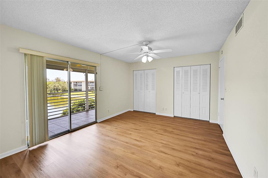 1902 Bermuda Circle, Unit H3 Coconut Creek, FL 33066 - Photo 18 of 25 wooden floor in an empty room with a window