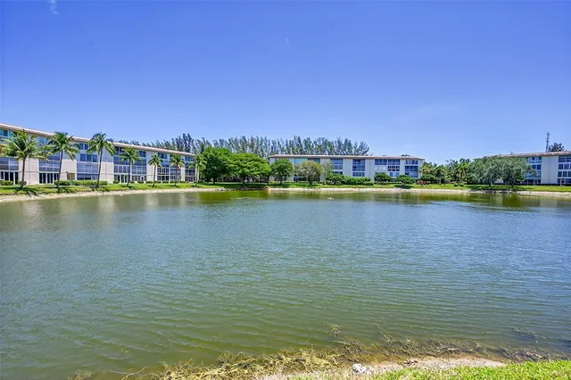 a view of a lake with houses in the back