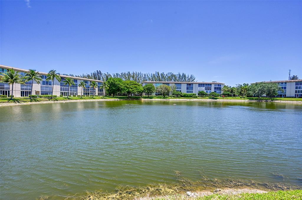1902 Bermuda Circle, Unit H3 Coconut Creek, FL 33066 - Photo 3 of 25 a view of a lake with houses in the back