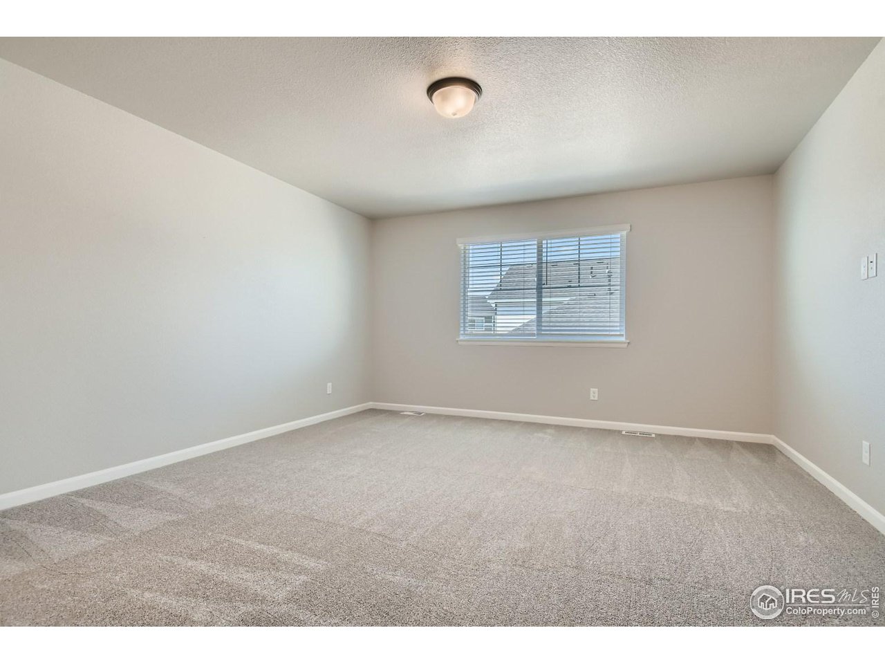 2540 Brookstone Drive, Unit B Milliken, CO 80543 - Photo 12 of 25 a view of an empty room with a window