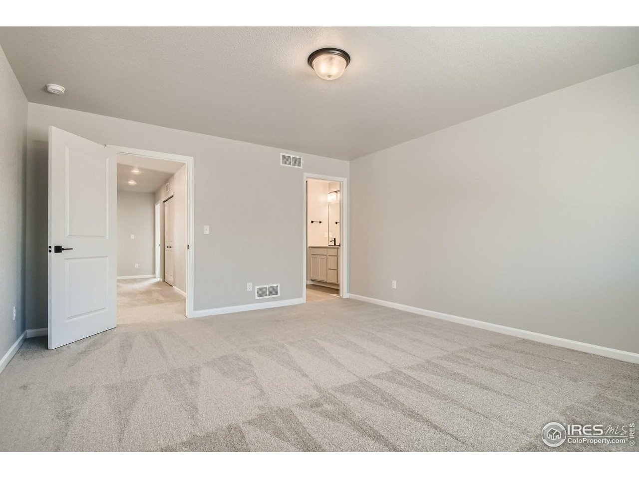 2540 Brookstone Drive, Unit B Milliken, CO 80543 - Photo 13 of 25 a view of an empty room with wooden floor